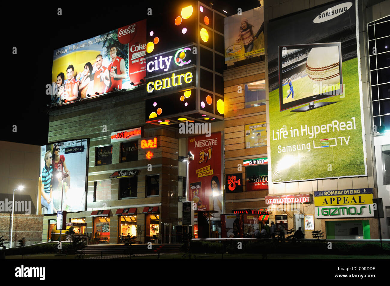 Shopping mall lit up at night, DLF City Centre Mall, MG Road, Gurgaon, Haryana, India Stock Photo