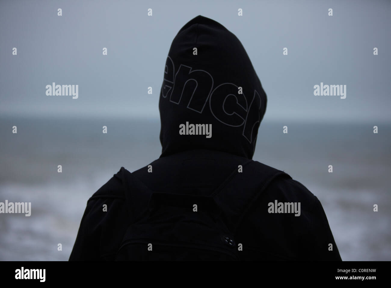 lone figure looking out to sea Stock Photo