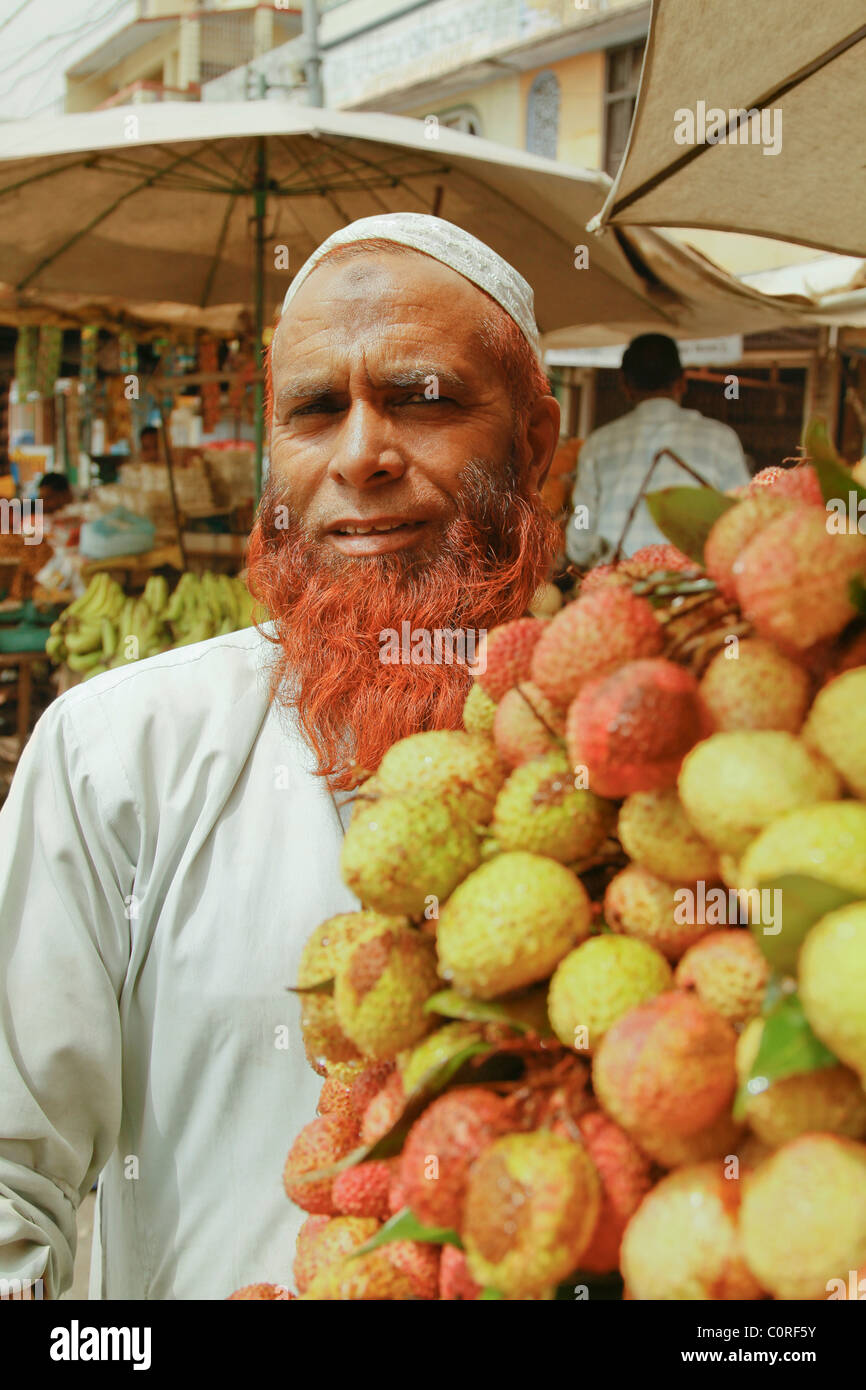 Portrait of a man standing at a fruit stall Stock Photo Alamy
