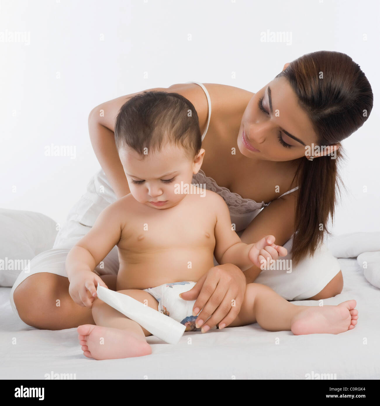 Woman playing with her son on the bed Stock Photo