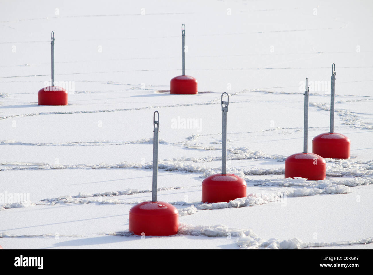 Red buoys in a frozen bay Stock Photo