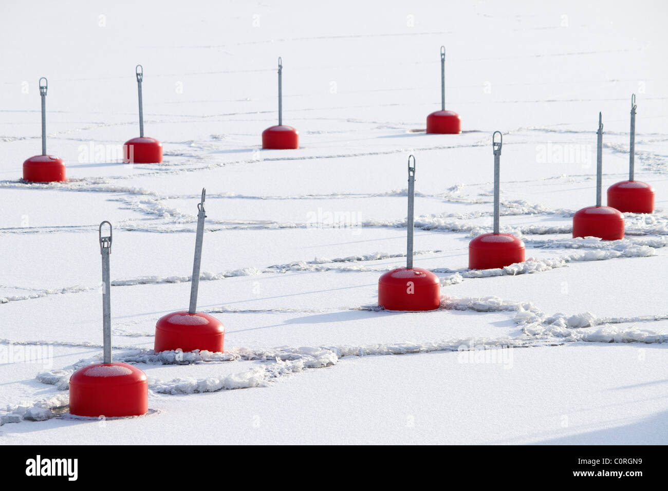 Red buoys in a frozen bay Stock Photo