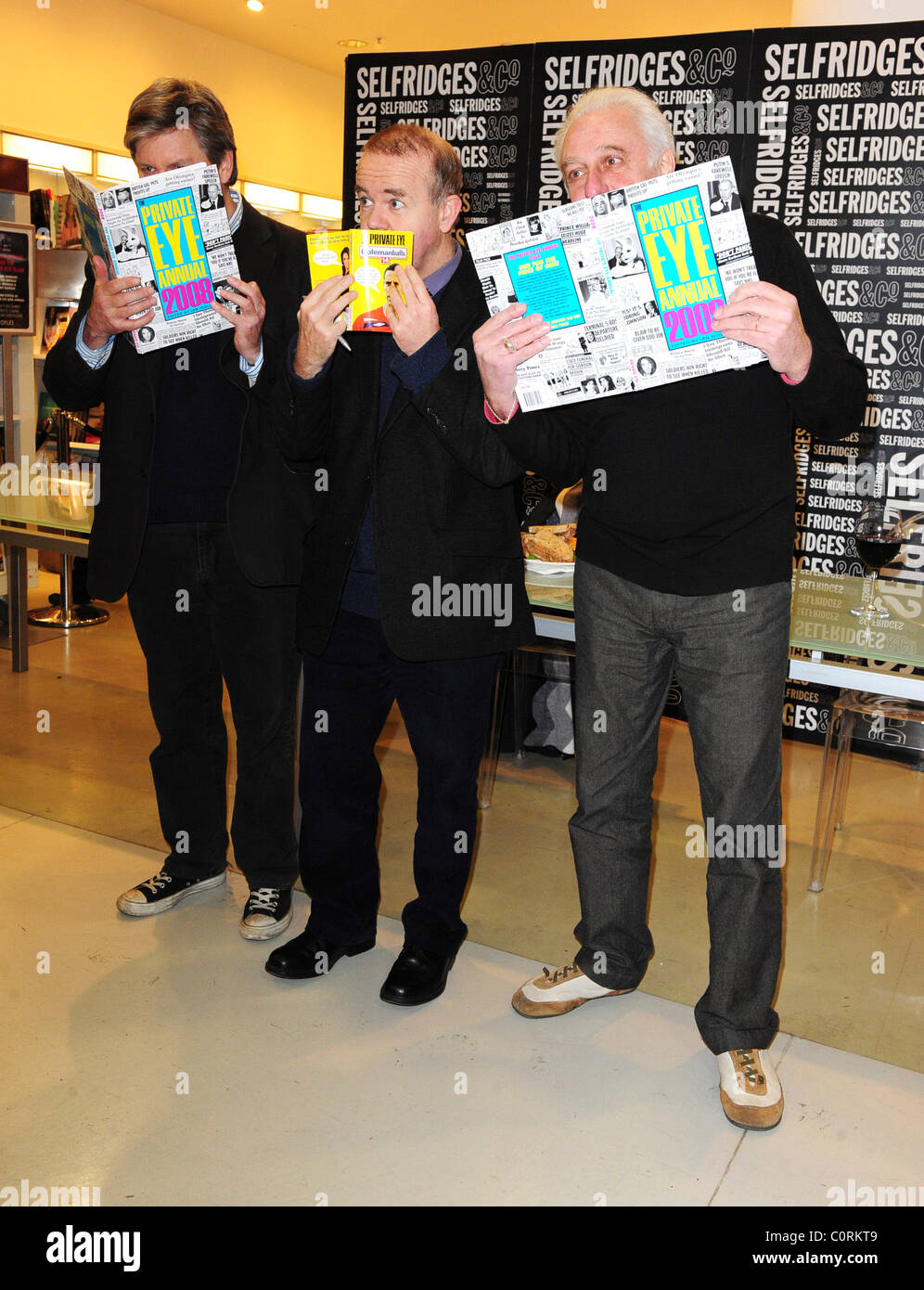 Nick Newman, Ian Hislop and Barry Fantoni signing copies of the Private Eye annual for 2008 at Selfridges London, England - Stock Photo