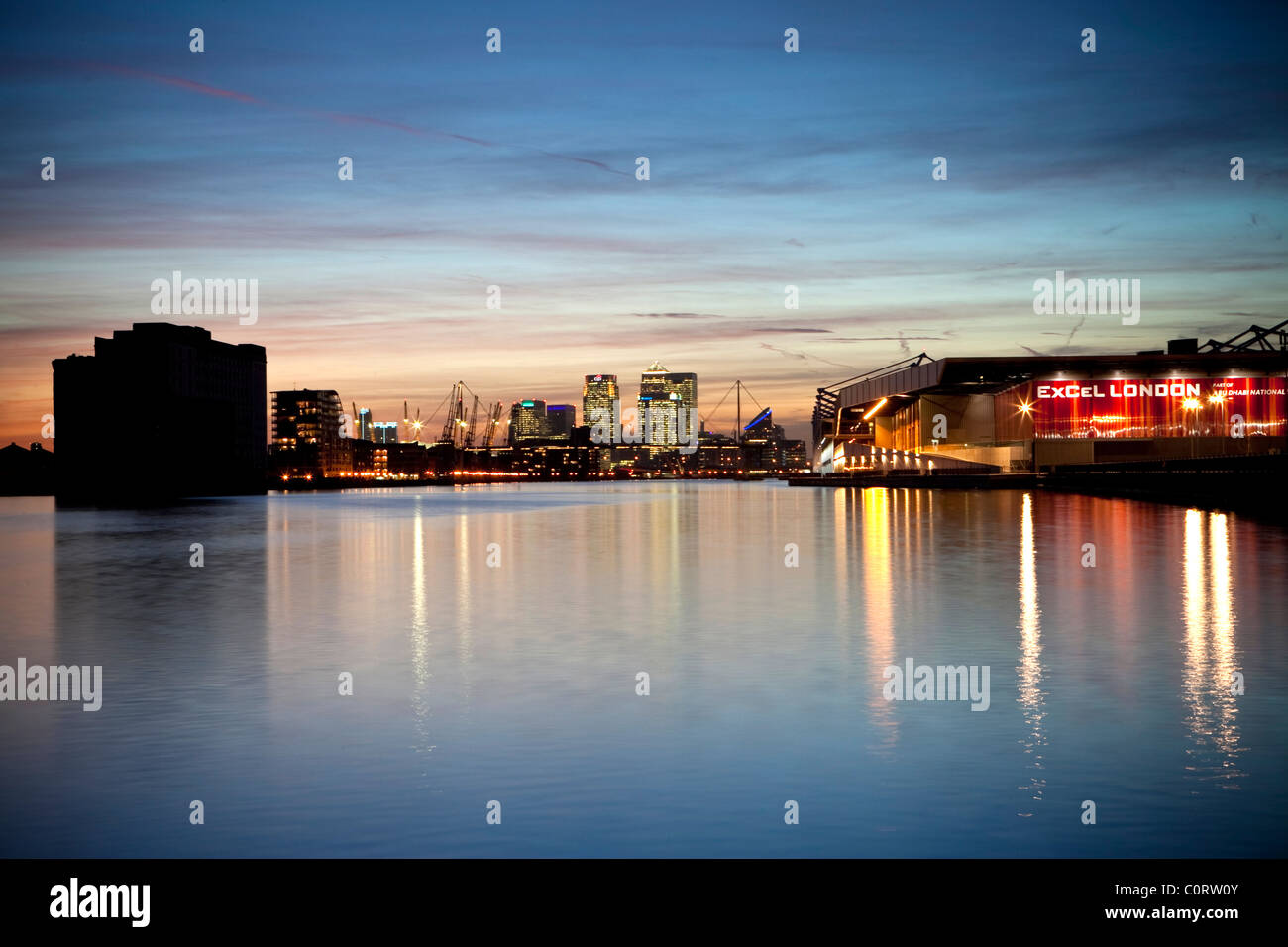 Isle of Dogs, Londons financial and the Excel Centre at dusk reflected in the waters of the Royal Victoria Dock Stock Photo