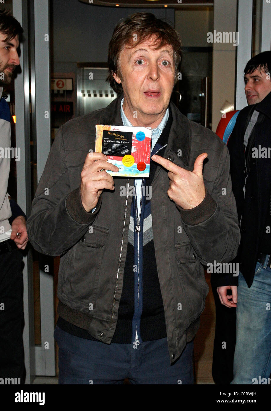 Paul McCartney holds up the new album from his band 'The Fireman' as he ...