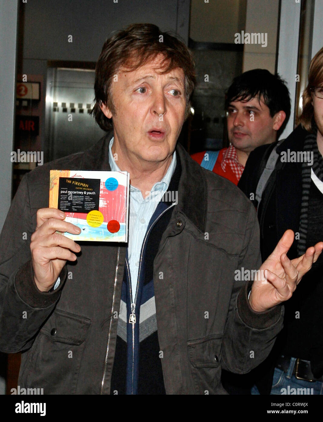 Paul McCartney holds up the new album from his band 'The Fireman' as he ...