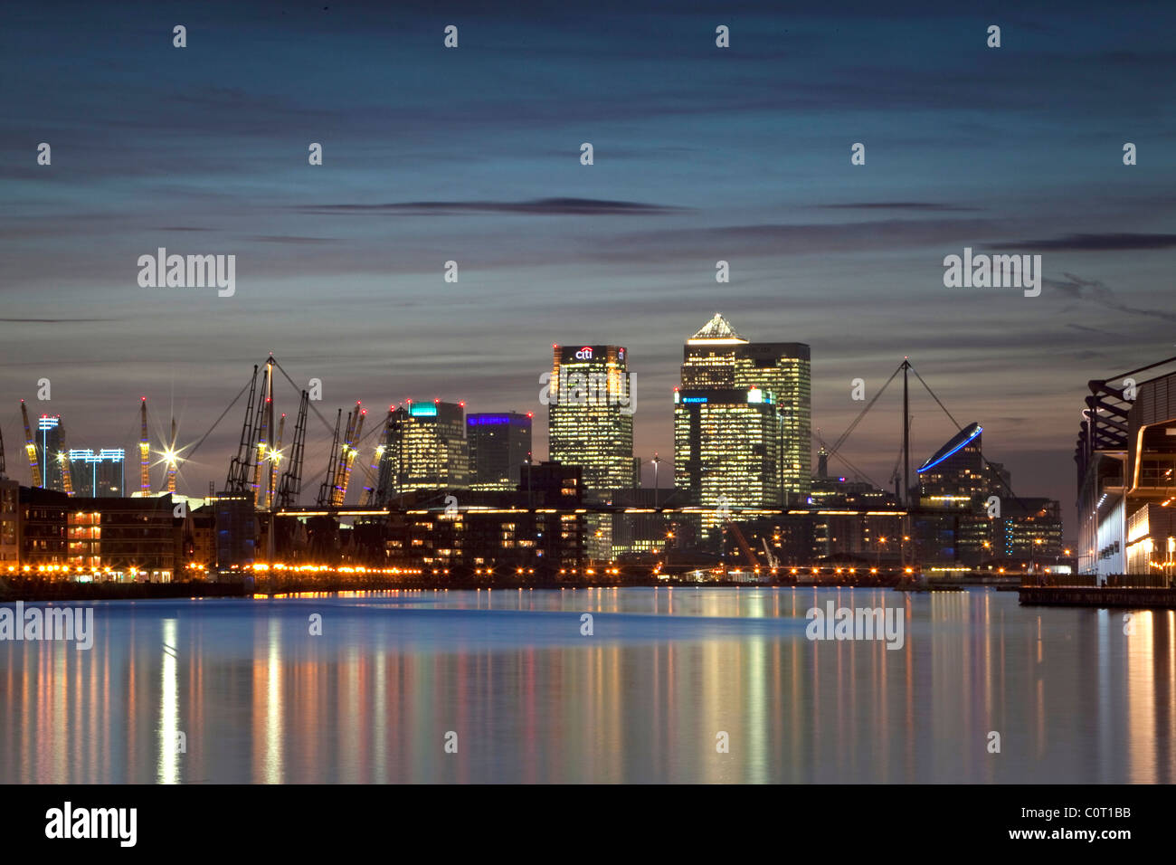 Isle of Dogs, Londons financial centre at dusk reflected in the waters of the Royal Victoria Dock Stock Photo