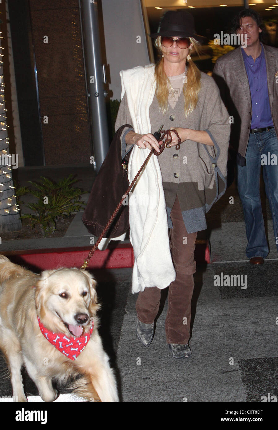 Nicollette Sheridan goes shopping in Beverly Hills with her pet labrador  dog wearing a poncho and cowboy boots and what seems Stock Photo - Alamy