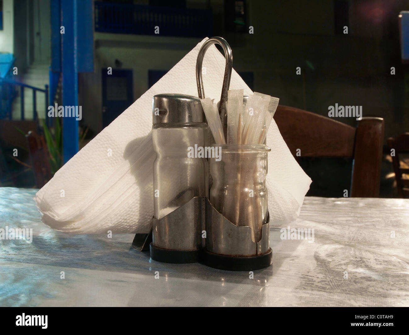 Paper napkins, salt, pepper, and toothpicks on the table of a taverna Stock Photo