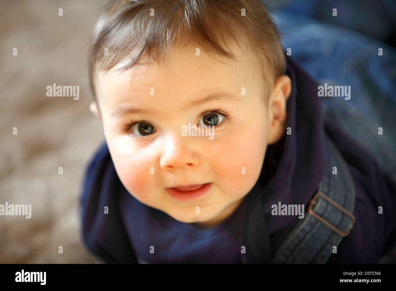 Baby boy, 10 month old, smiling friendly, at home. Stock Photo