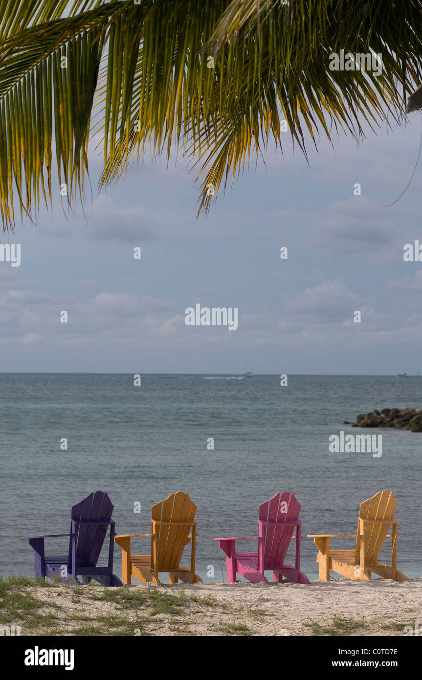 Brightly colored chairs on the beach in Aruba. Stock Photo