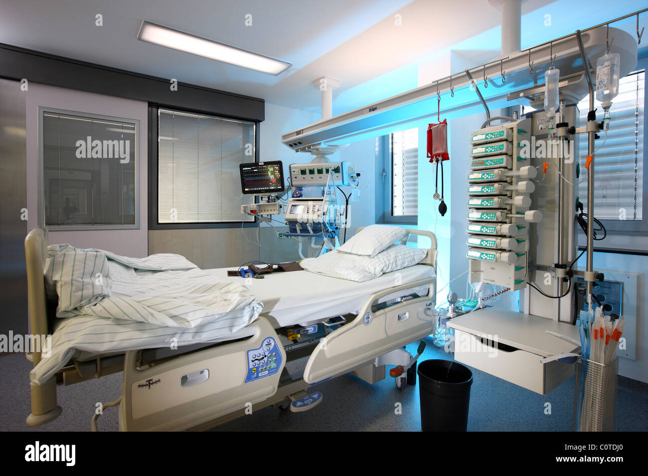 Intensive care unit in a hospital. A patient is connected to different ...