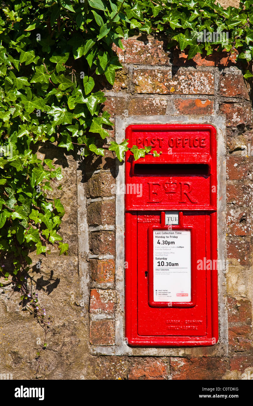 British mail box set in to a stone wall with ivy showing Stock Photo