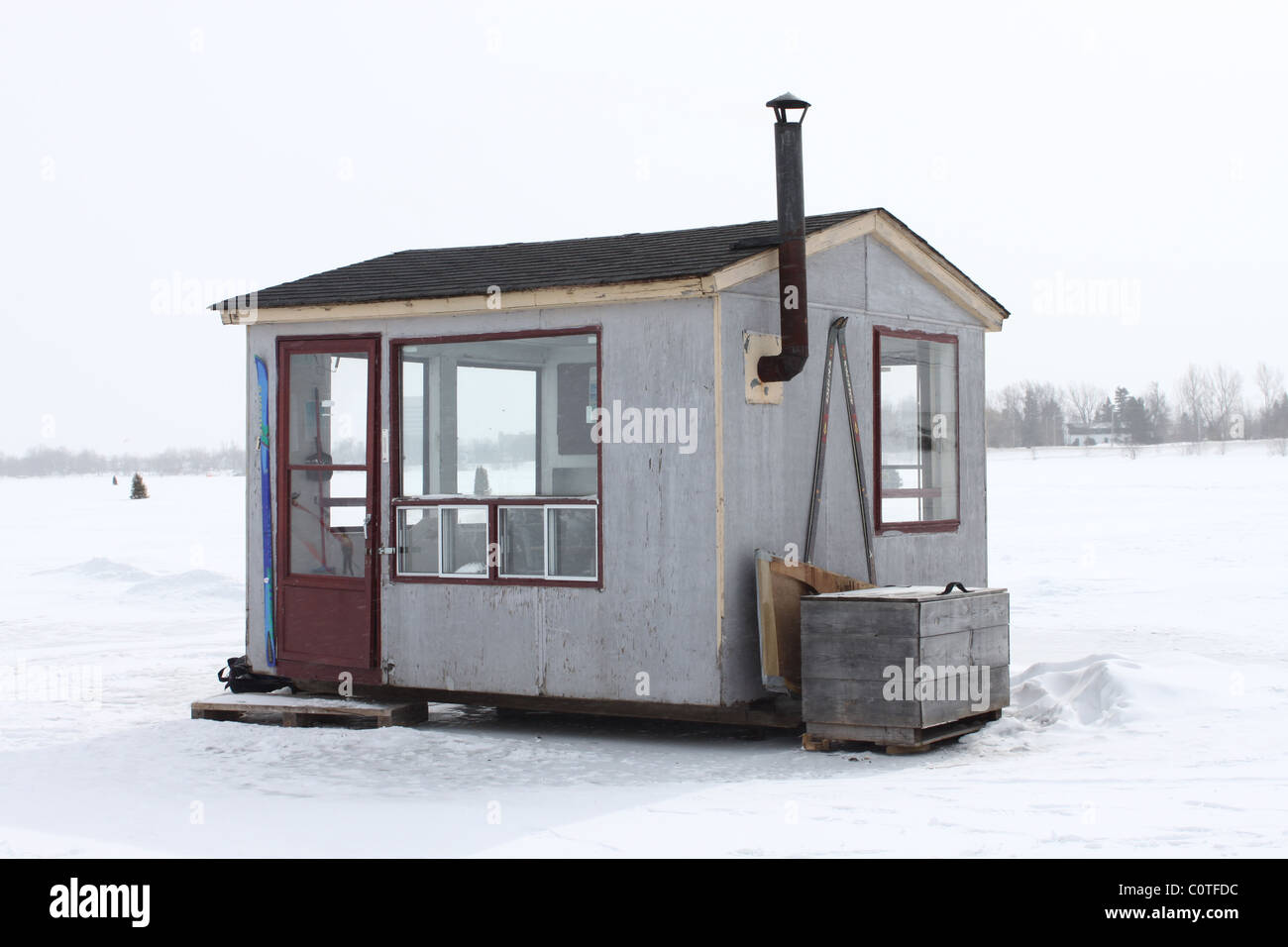 Ice fishing house with chimney on lake Stock Photo