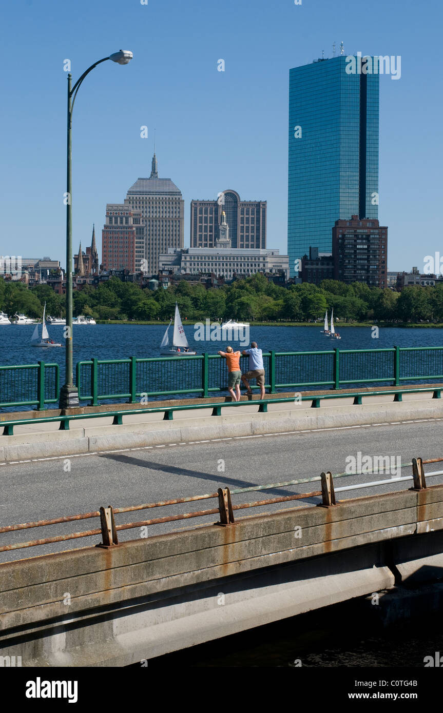 Two people enjoying a summer day watching the boats on the Charles river in Boston, MA. Stock Photo
