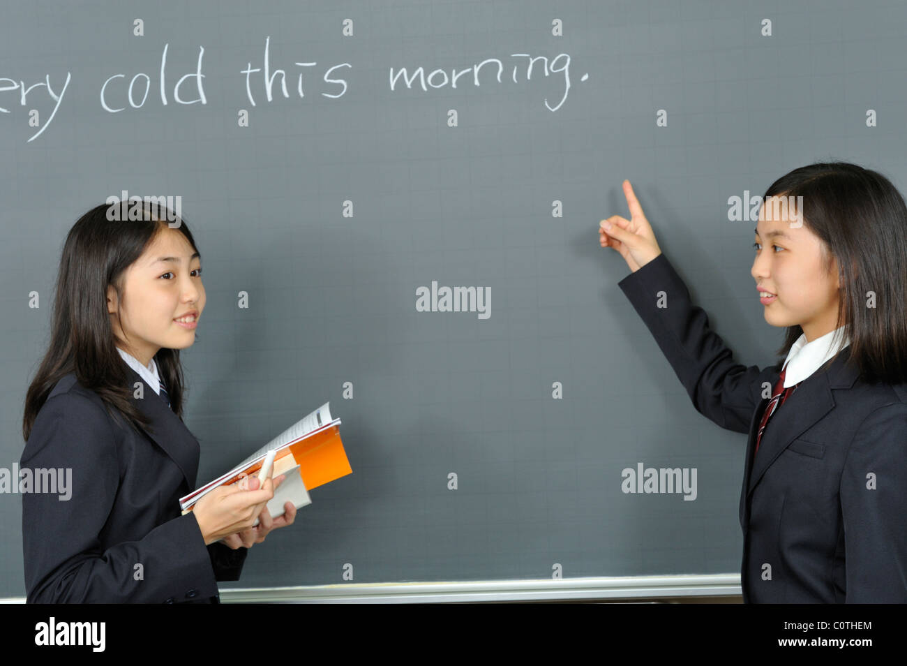 High School Girls Standing in front of Blackboard Stock Photo - Alamy