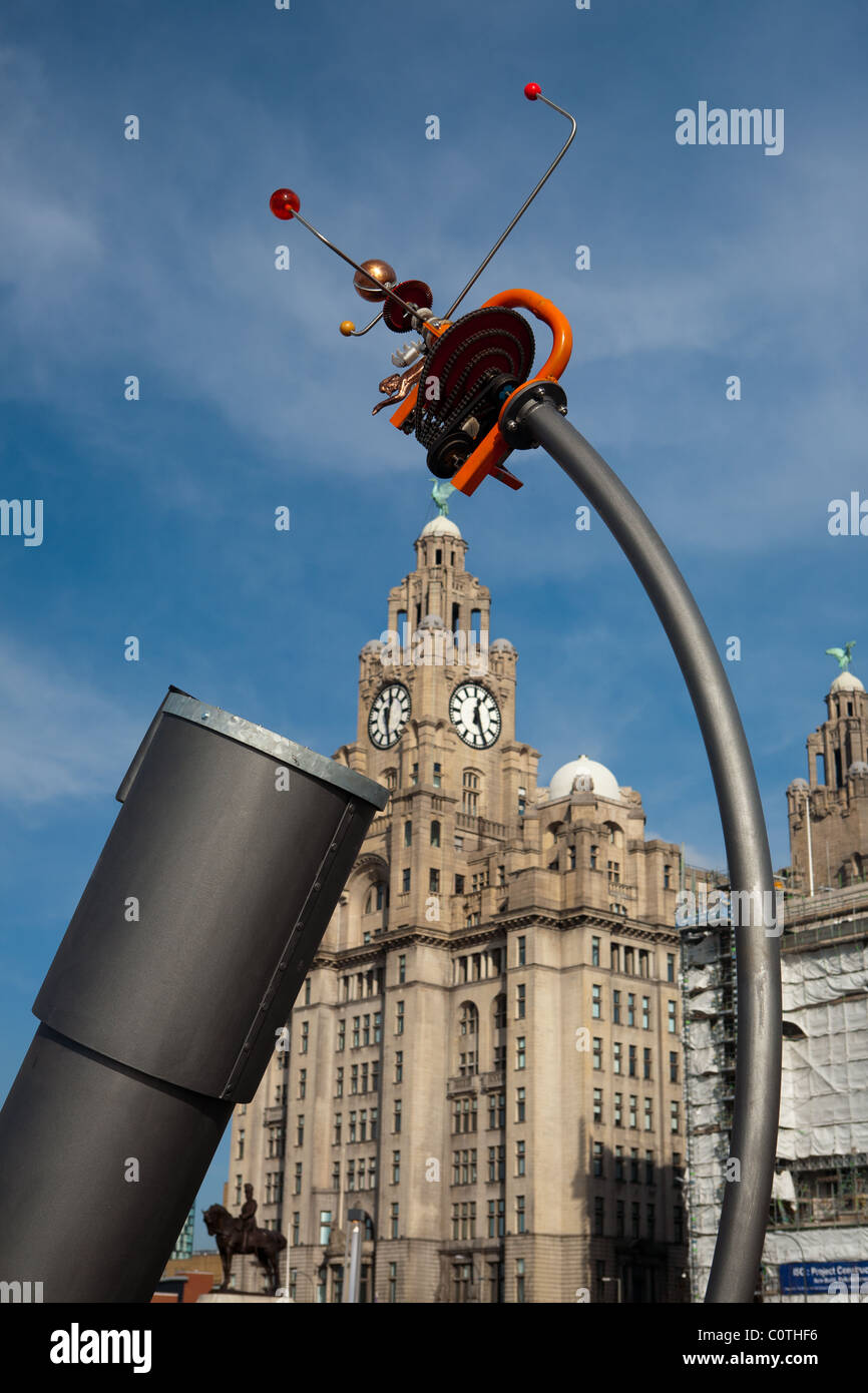 A Modern Sculpture on the side of the River Mersey in Liverpool, the Liver building with the liver birds in the background Stock Photo