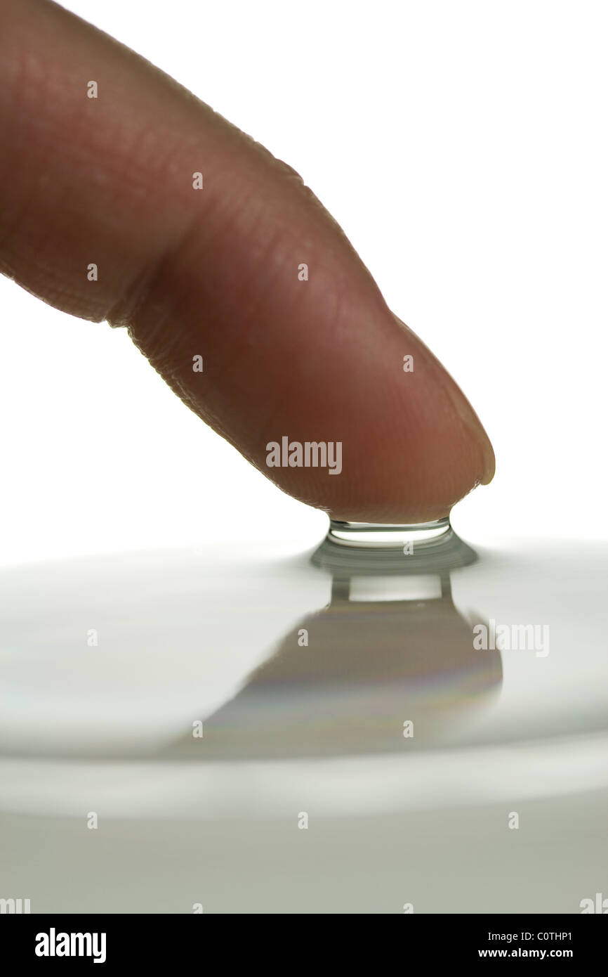 Finger Demonstrating Surface Tension of Water Stock Photo