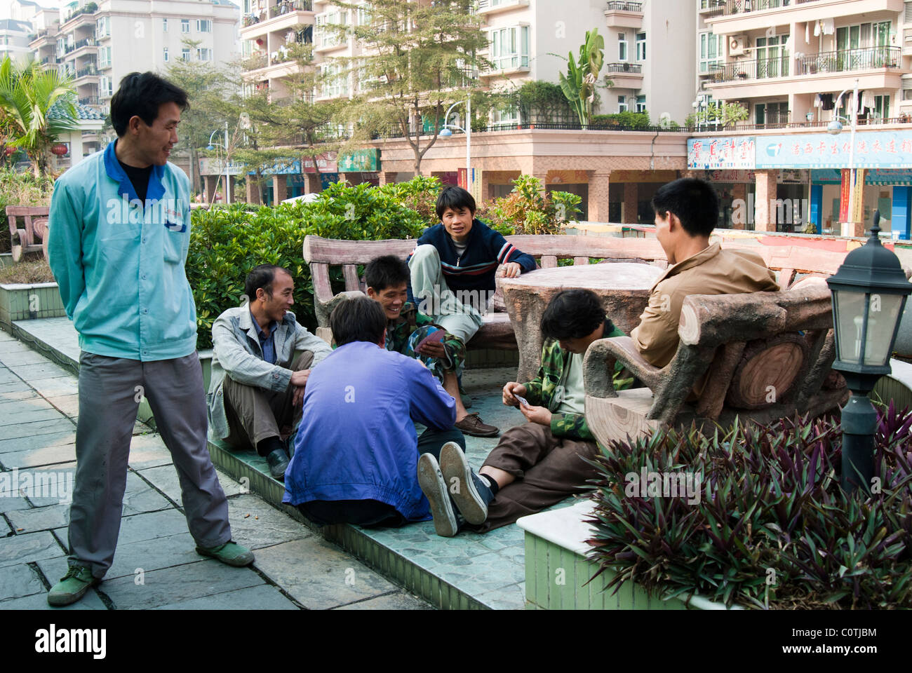 Chinese men playing cards outside, Dongguan, China Stock Photo