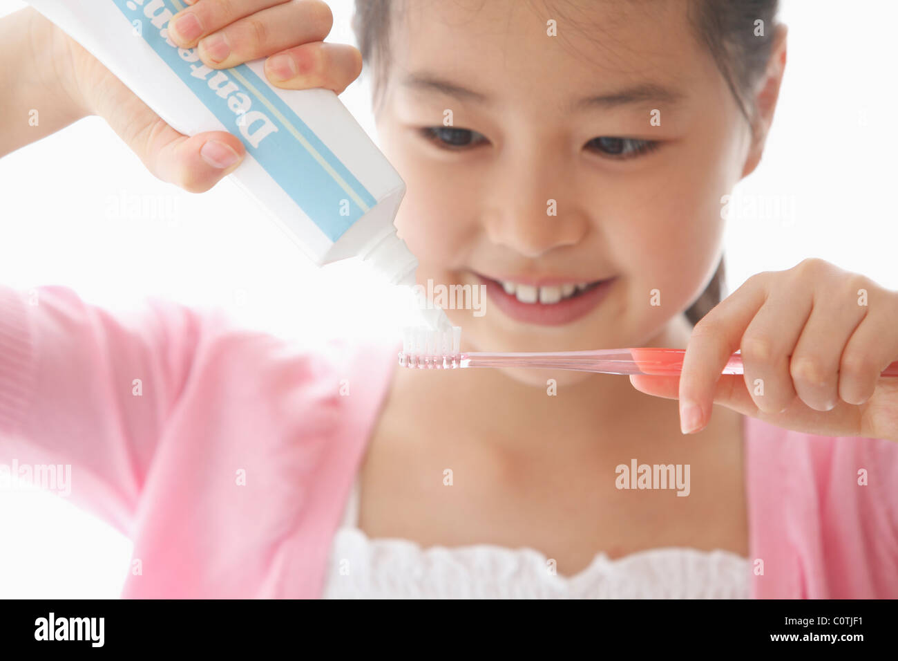 Girl Squeezing Toothpaste Tube Stock Photo Alamy