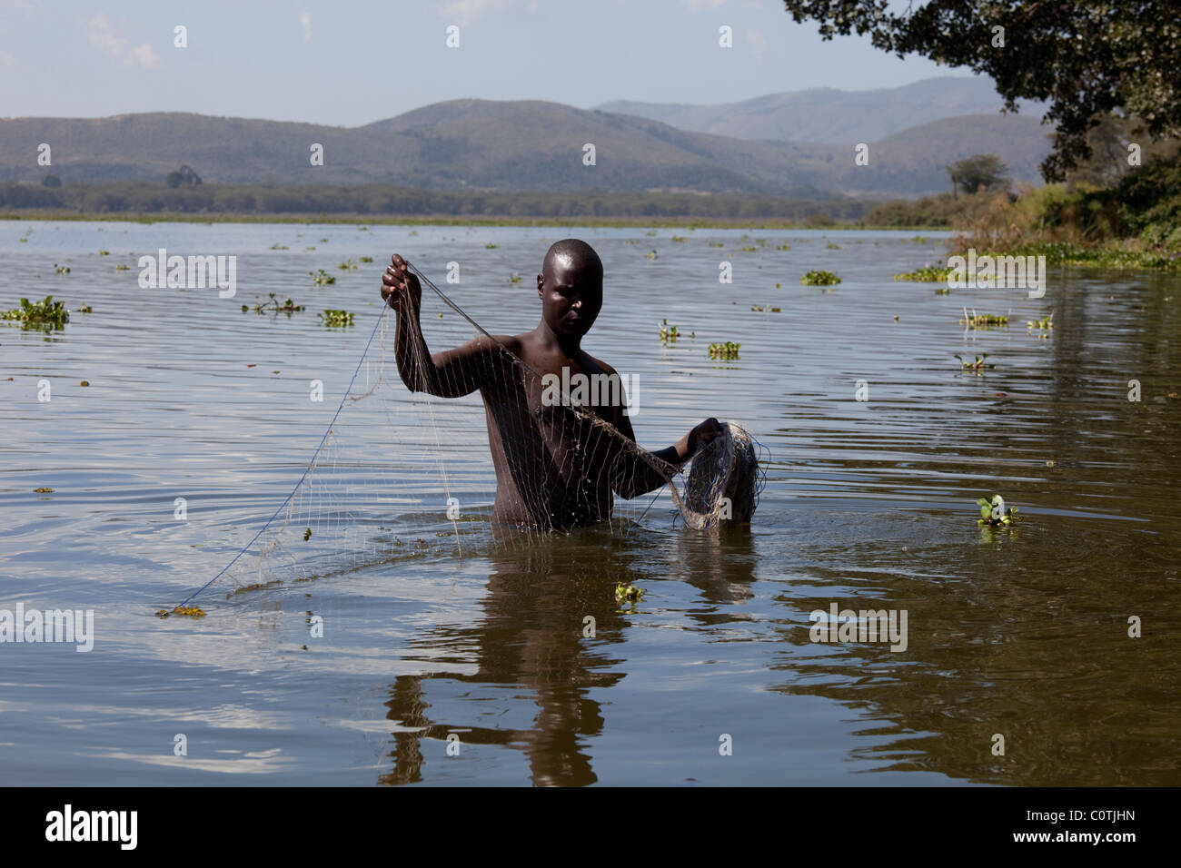 Local fisherman wading with nets Lake Naivasha Rift Valley Kenya Stock Photo
