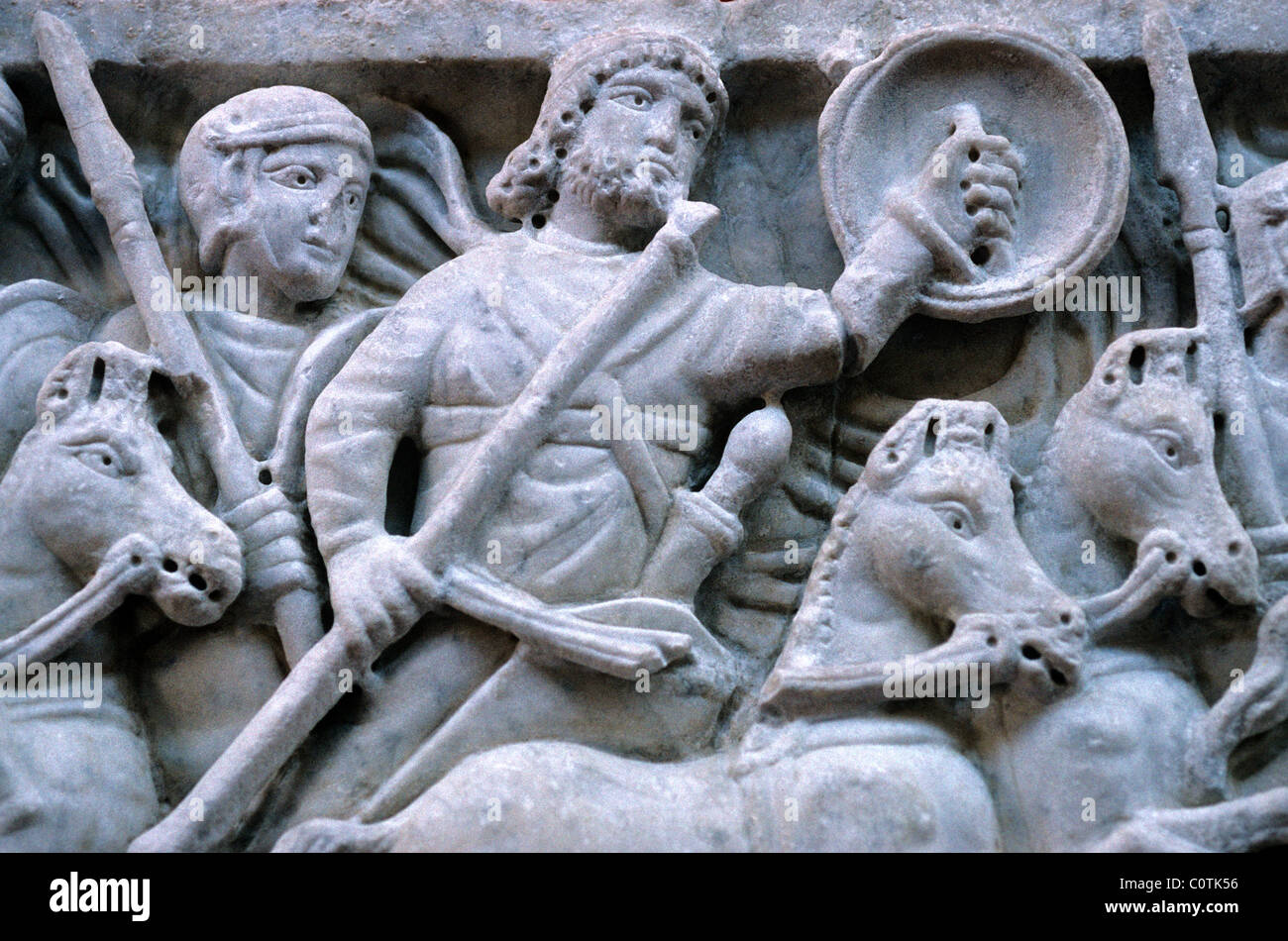 Bas Relief or Stone Carving of Roman Soldiers, Horsemen or Cavalry in Battle Scene, Arles Archaeological Museum, France Stock Photo