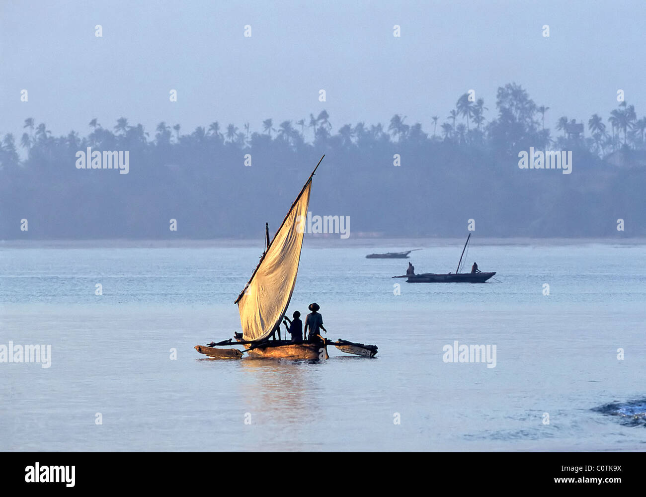 Fishermen sailing out to fish at sunrise, Bagamoyo, Tanzania Stock Photo