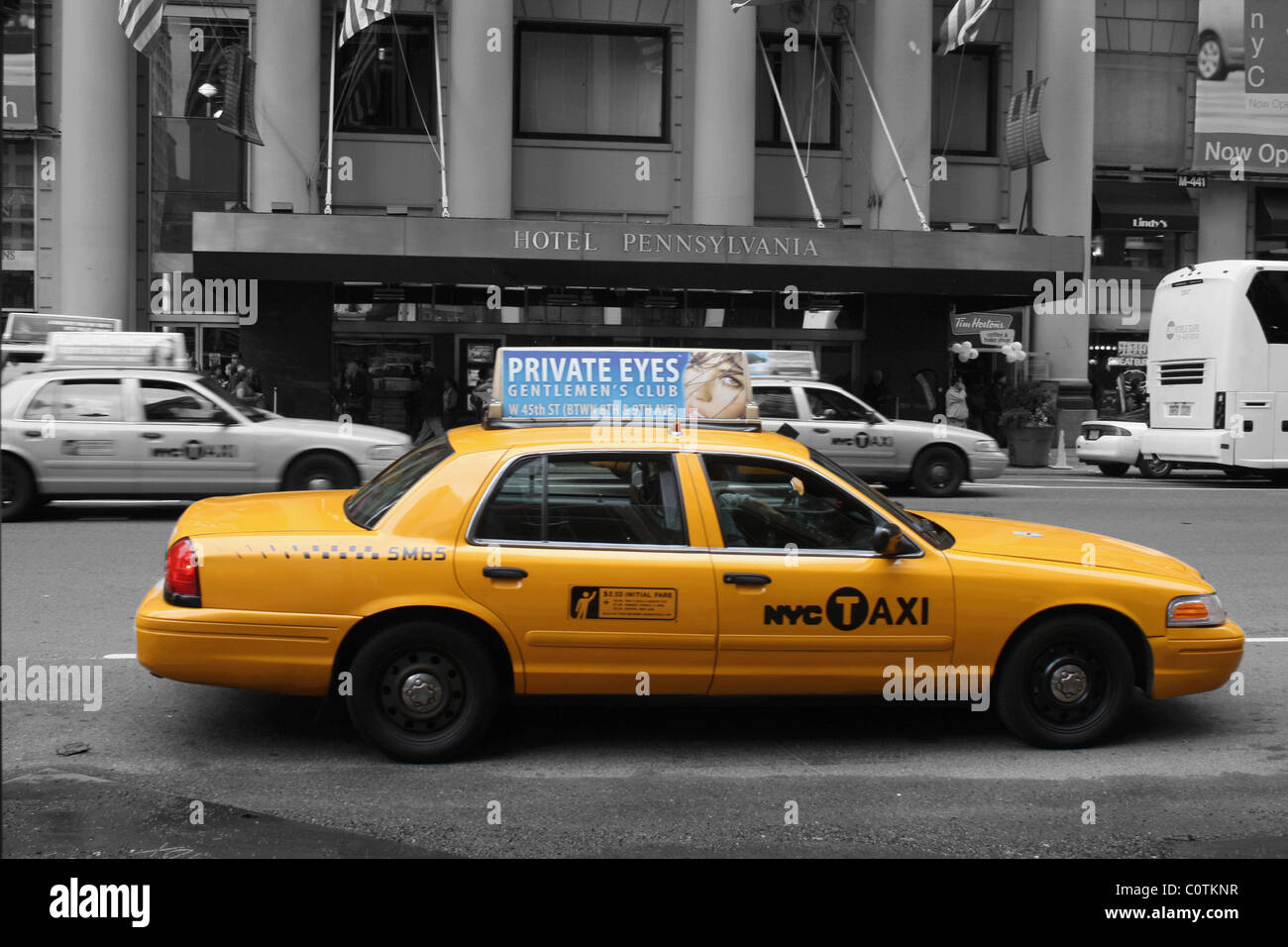 Selective color image of a New York taxi cab taken outside the Hotel Pennsylvania, 401 Seventh Ave, New York City. Stock Photo