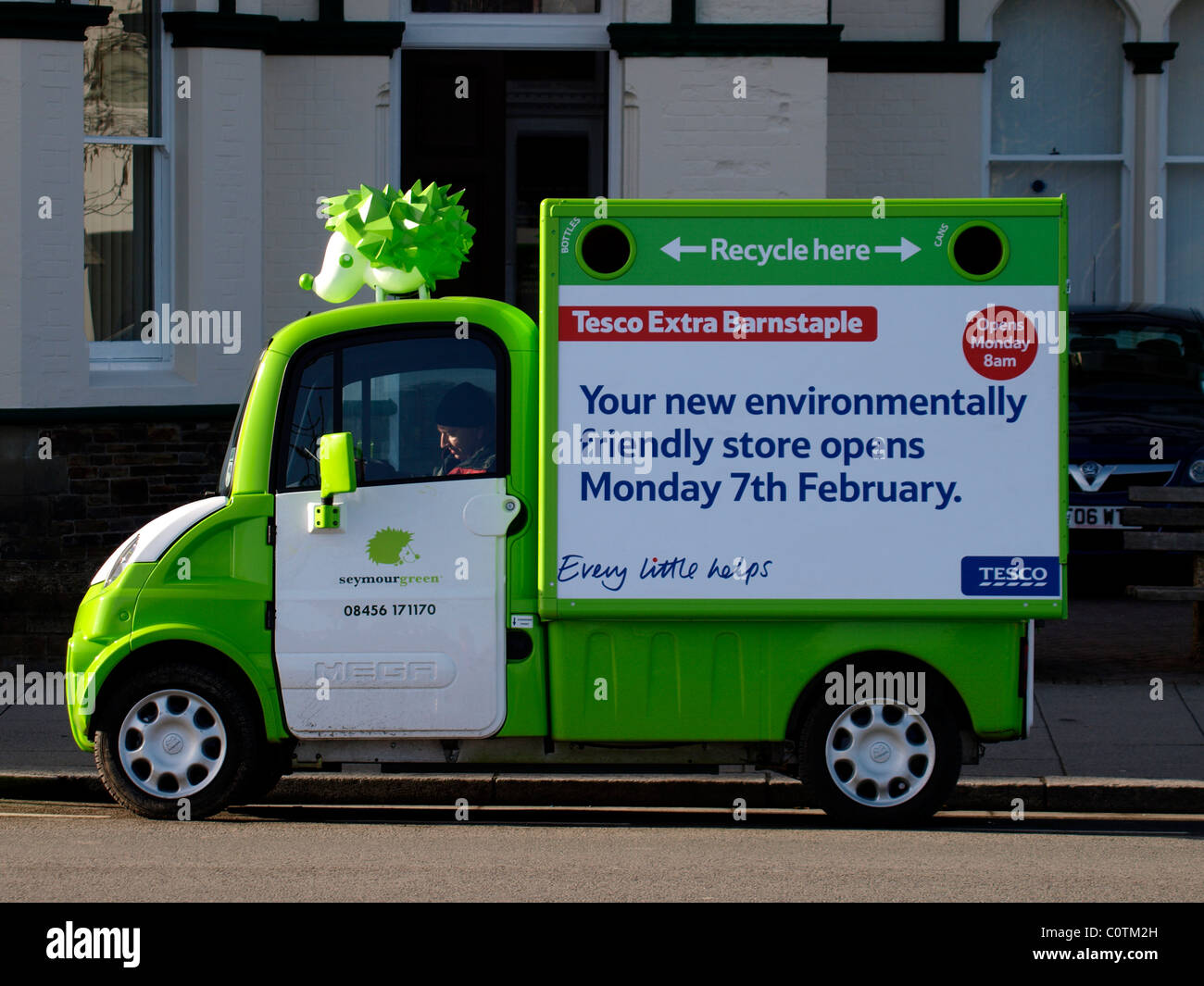 Small recycling truck advertising the opening of a new environmentally