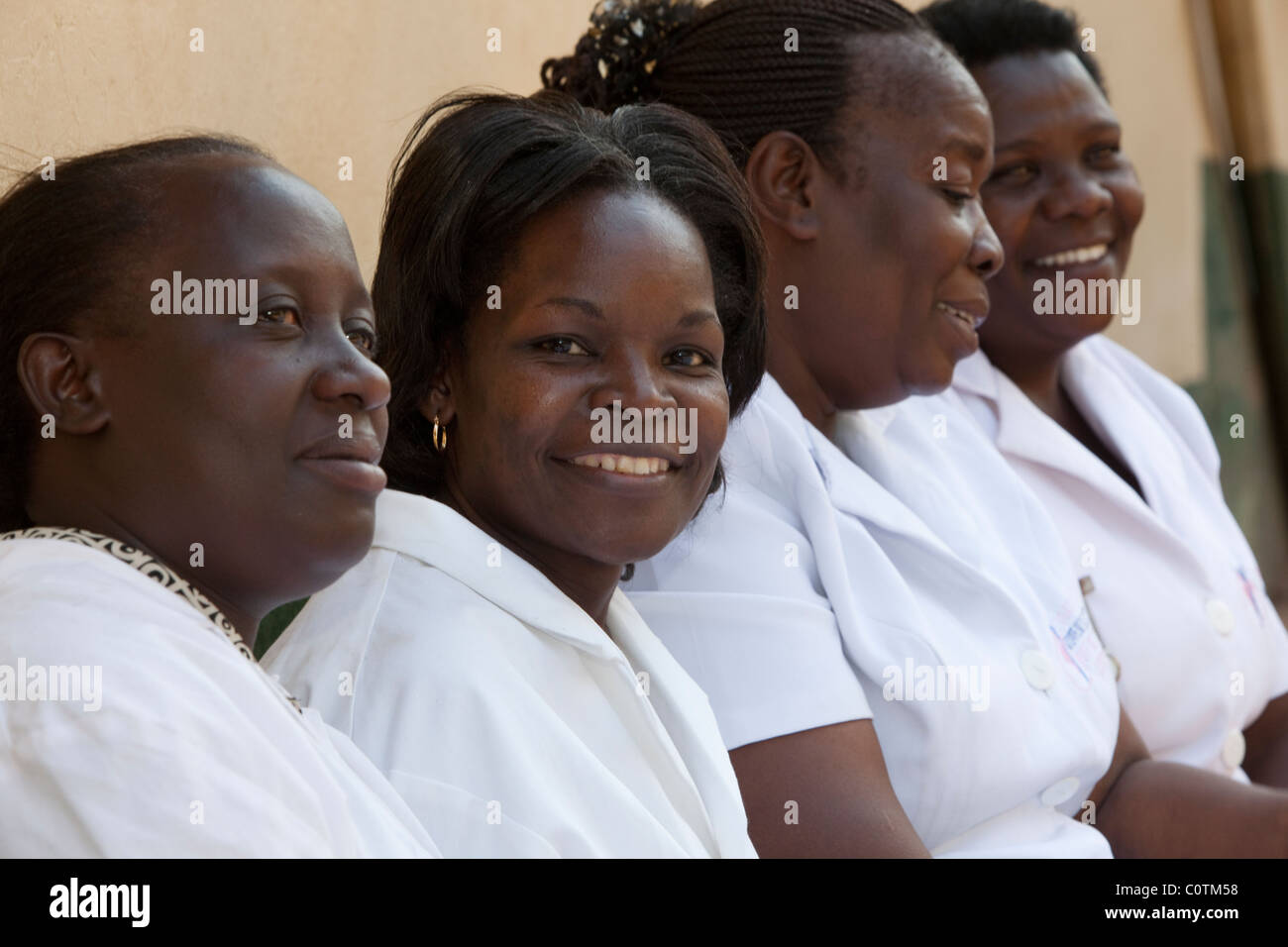 A group of nurses sit outside a clinic in Kampala, Uganda, East Africa. Stock Photo