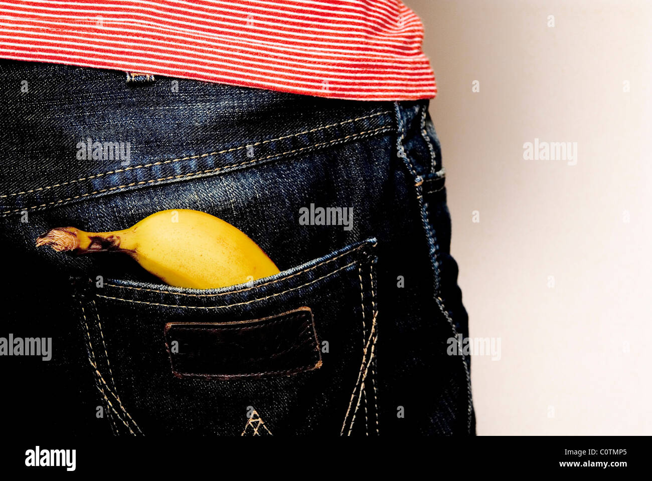 Banana in rear pocket of jeans with space for text or cut out Stock Photo