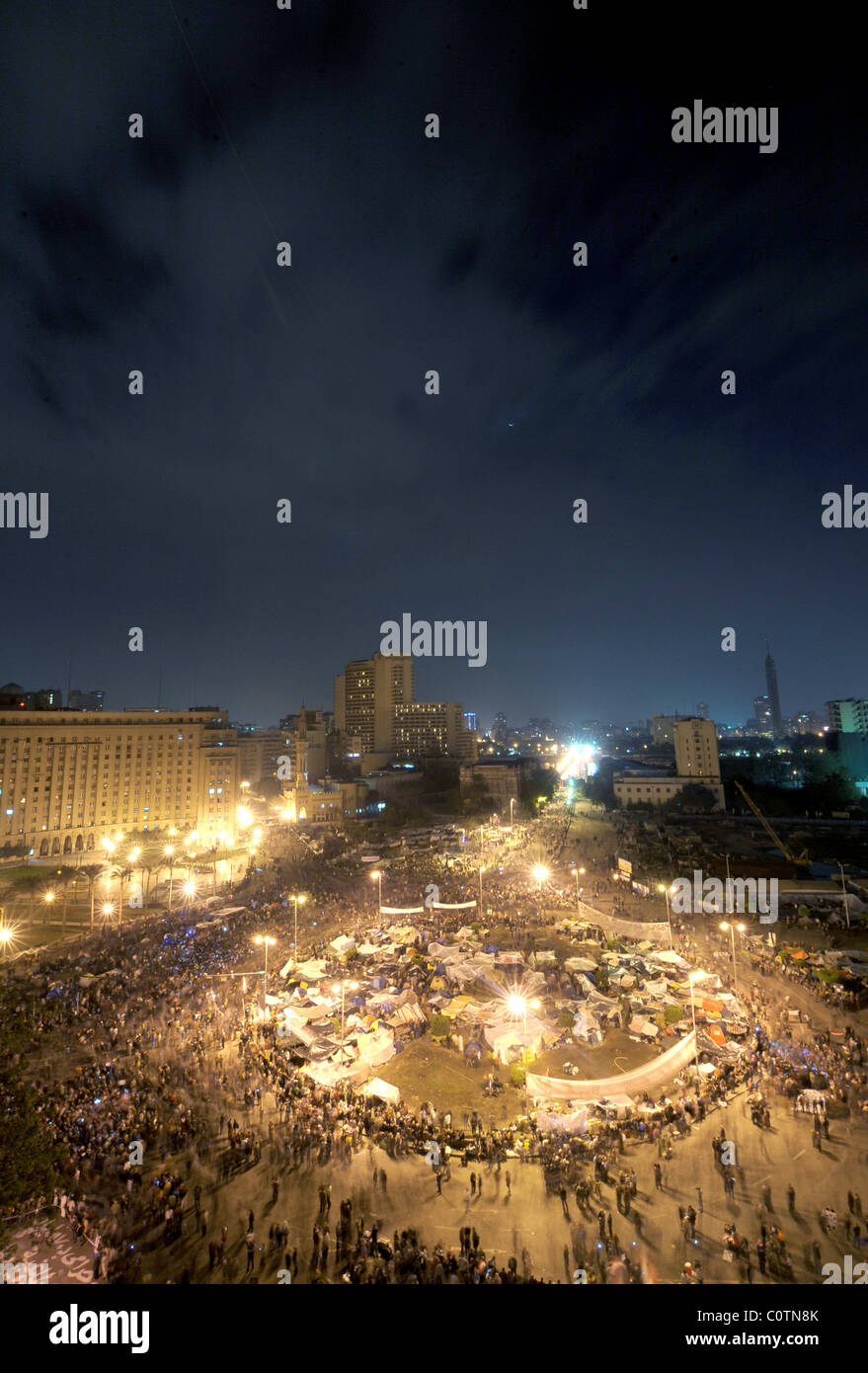 Overview of Tahrir square at dusk filled with anti-Mubarak protesters during the Egyptian revolution; Cairo, Egypt. Stock Photo