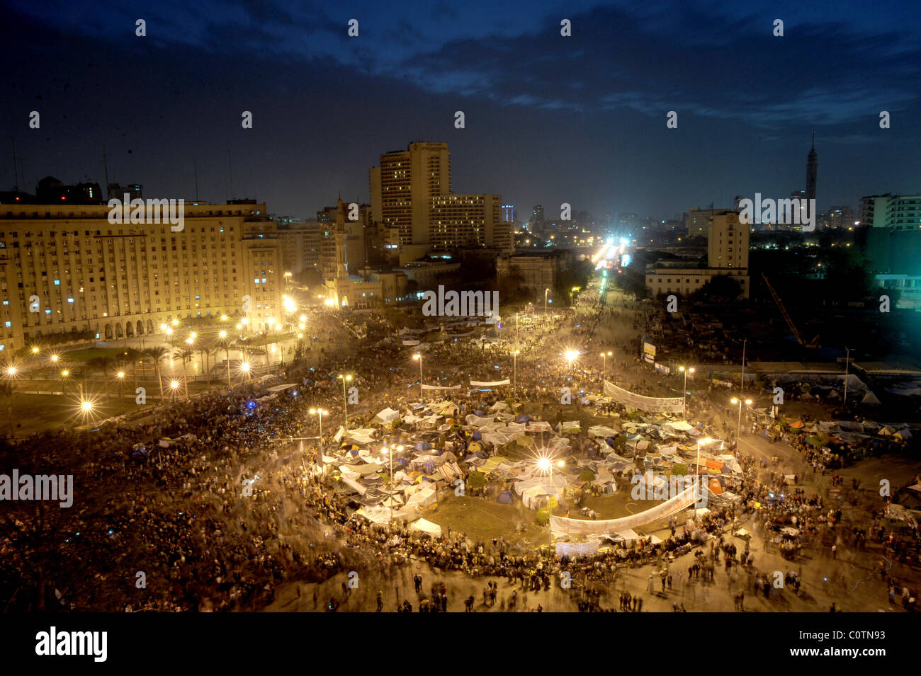 Overview of Tahrir square at dusk filled with anti-Mubarak protesters during the Egyptian revolution; Cairo, Egypt. Stock Photo