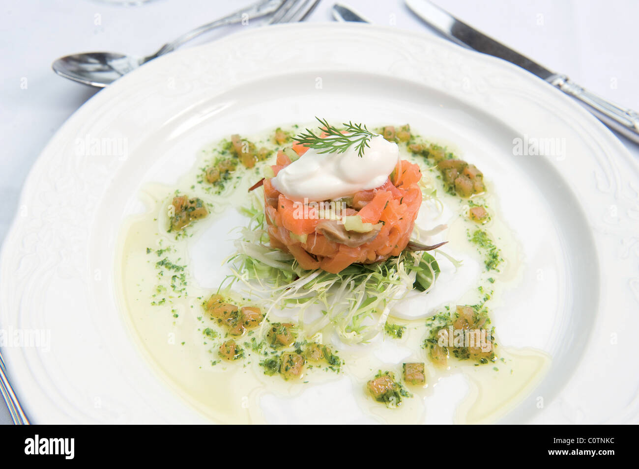 Cured wild salmon with fresh horseradish and creme fraiche Stock Photo