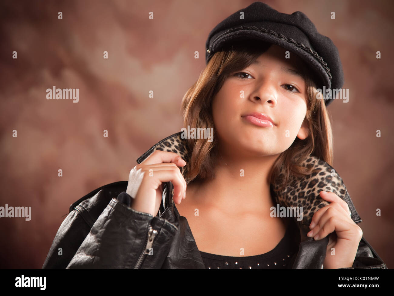 Cute Hispanic Girl with Hat and Leather Jacket Studio Portrait Stock
