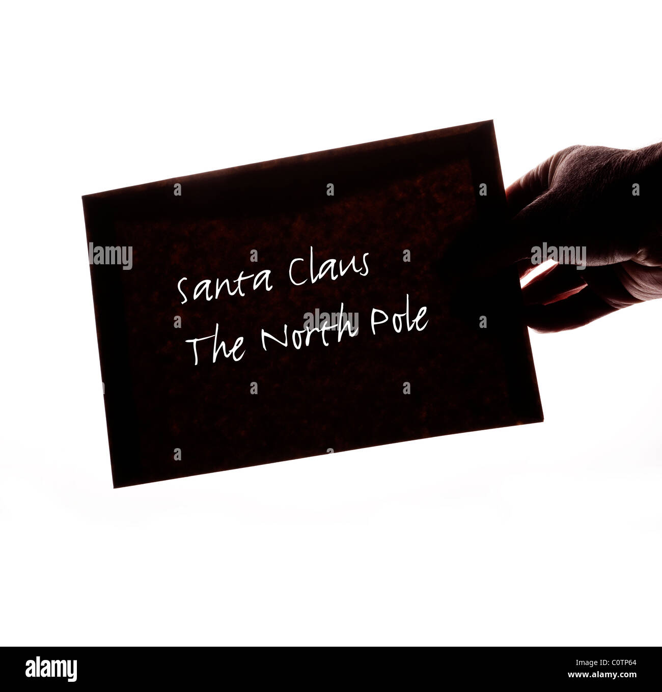 Hand holding an envelope addressed to Santa Clause, The North Pole, on