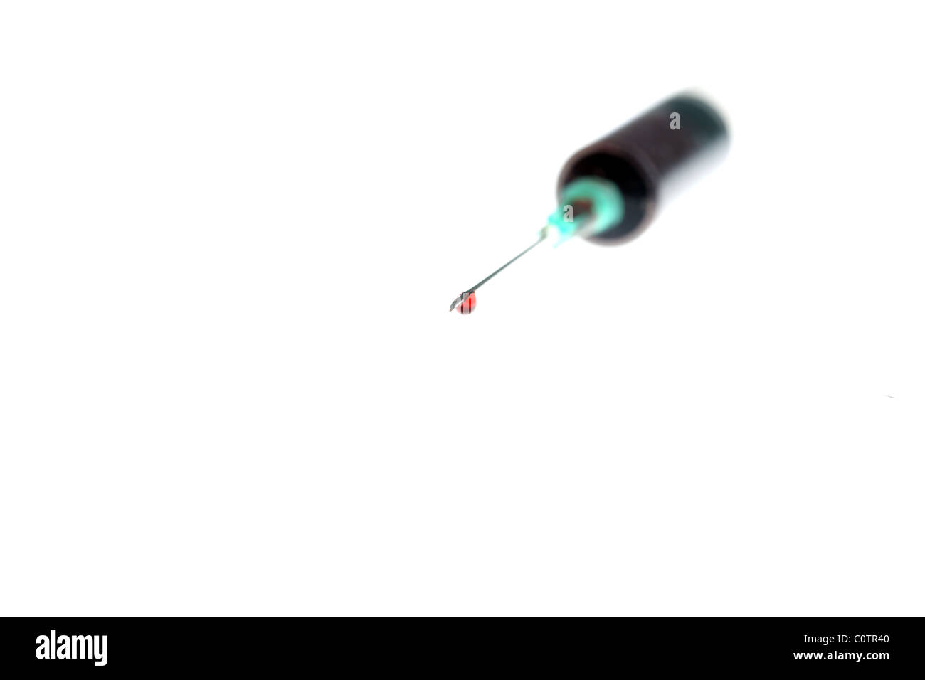 Blood dripping from a hypodermic needle Stock Photo