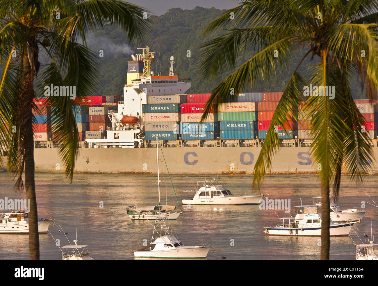 PANAMA CITY, PANAMA - Freighter passes marina at Amador Causeway, as it enters Panama Canal. Stock Photo