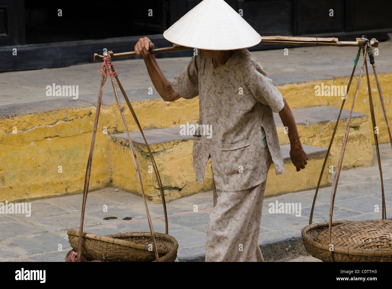 Vietnamese woman caring  baskets in Hoi Ann, Vietnam Stock Photo