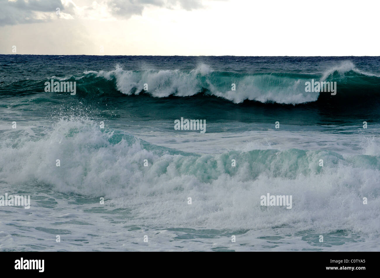 Waves breaking over the rocks and beach at Paphos in Cyprus Stock Photo