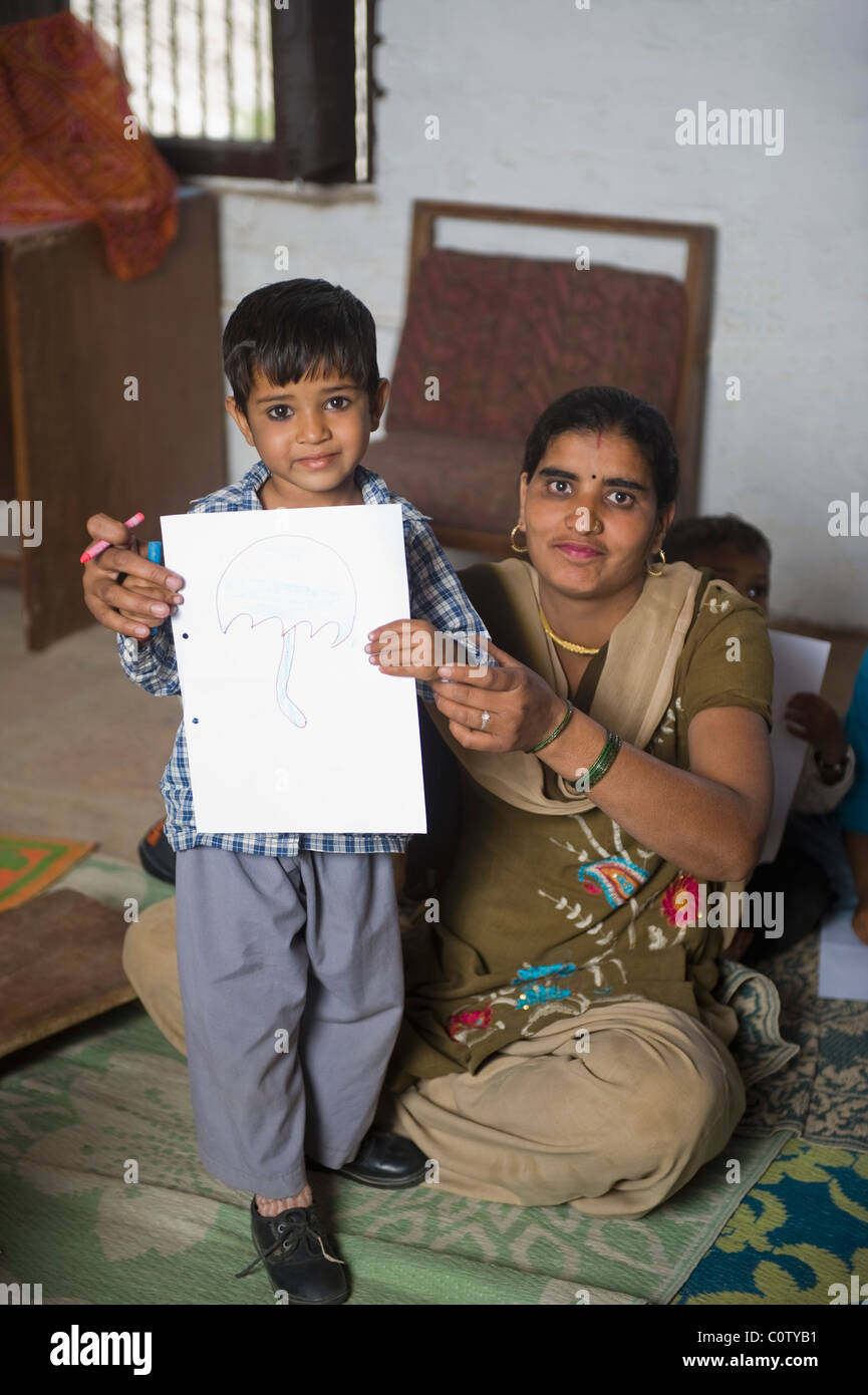 Boy with his teacher showing a drawing Stock Photo