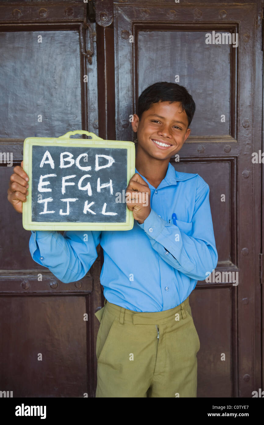 Portrait of a schoolboy holding a slate and smiling Stock Photo