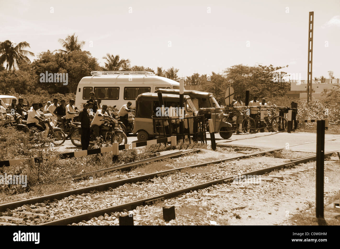 People waiting at a railroad crossing, Tirupati, Andhra Pradesh, India Stock Photo