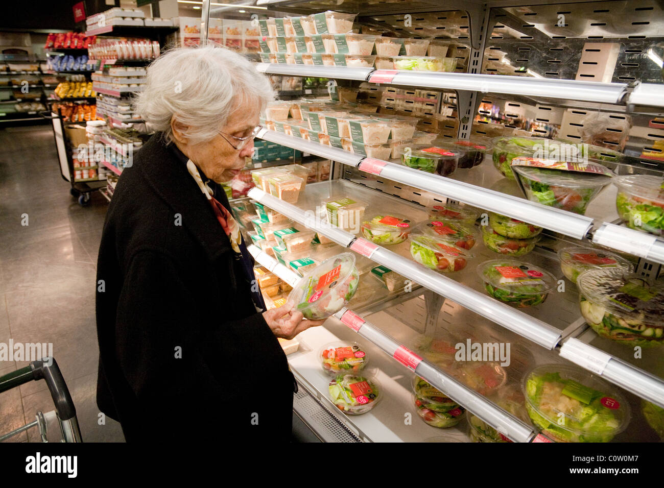 An elderly senior lady shopping for food, Marks and Spencer, M&S bromley, Kent UK Stock Photo