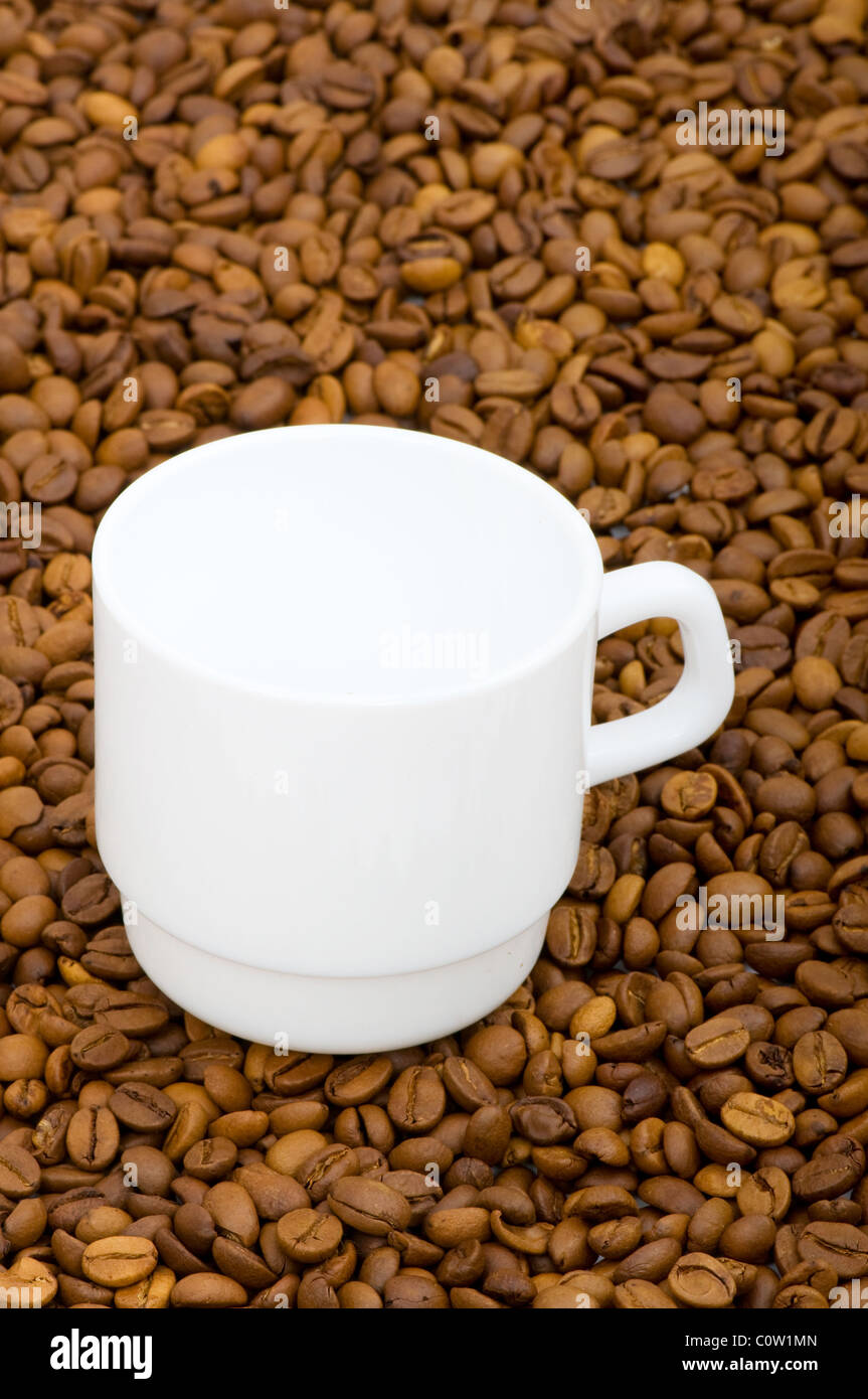 White cup and background of coffee beans Stock Photo - Alamy
