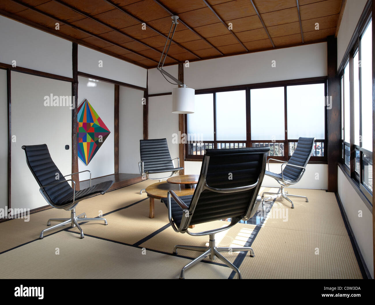 Contemporary tatami room in a japanese living room with C. Eames office  lounge chairs Stock Photo - Alamy