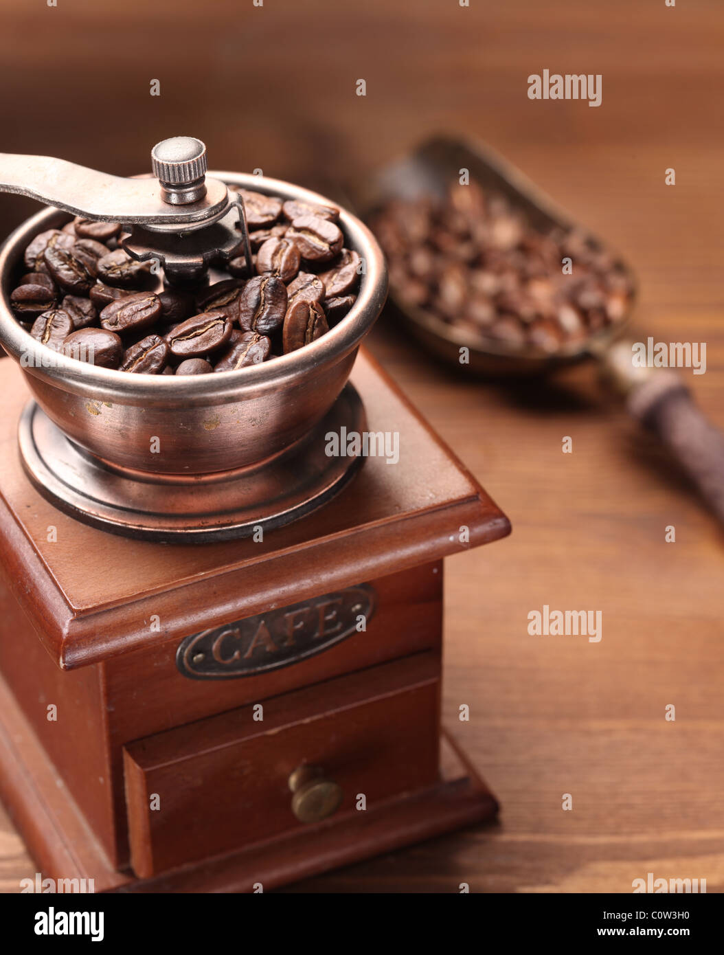 Roasted coffee beans are ground in a coffee grinder Stock Photo - Alamy