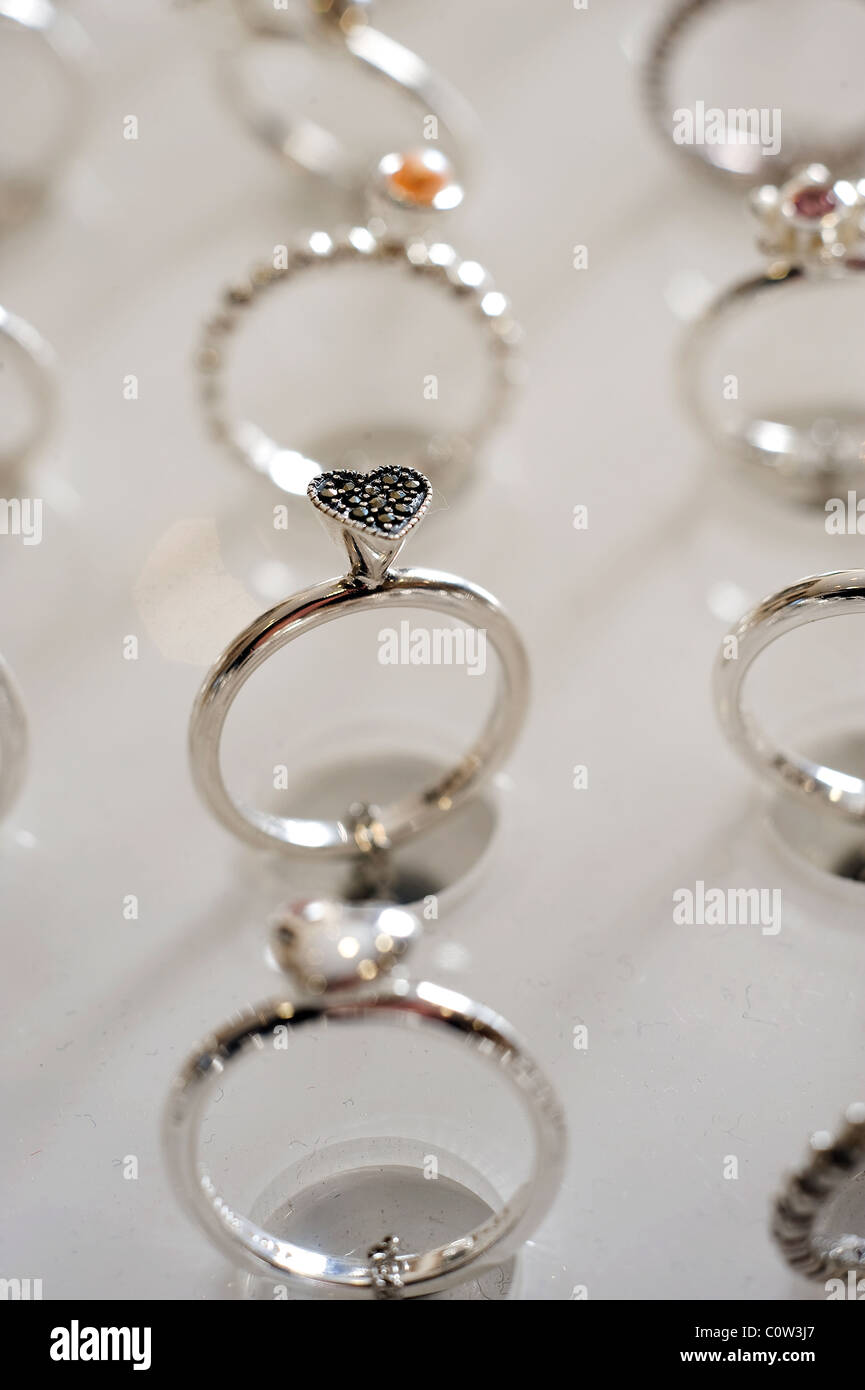 A selection of silver heart shaped rings Stock Photo