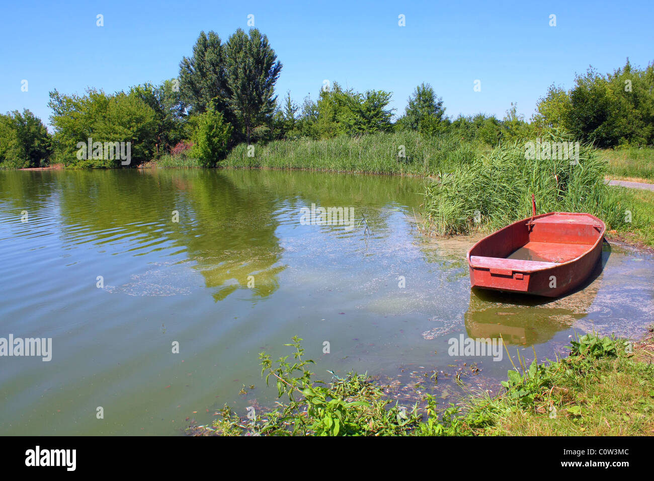 fishpond with red boat Stock Photo