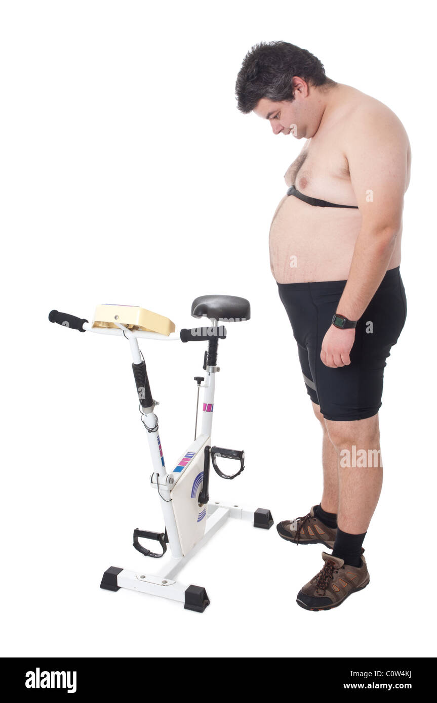 Fat man looking to a static bicycle Stock Photo